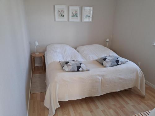 a white bed with two pillows in a bedroom at Sønderborg Kær Vestermark in Sønderborg