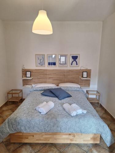 a bedroom with a bed with two towels on it at IL VIAGGIO DI COSIMO in San Vito lo Capo