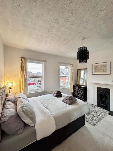 a bedroom with a large bed and a fireplace at Charming 2 Bed Terrace in Central Caversham in Caversham