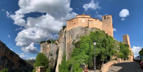 a castle on top of a mountain at El rincon de Adriana in Alquézar