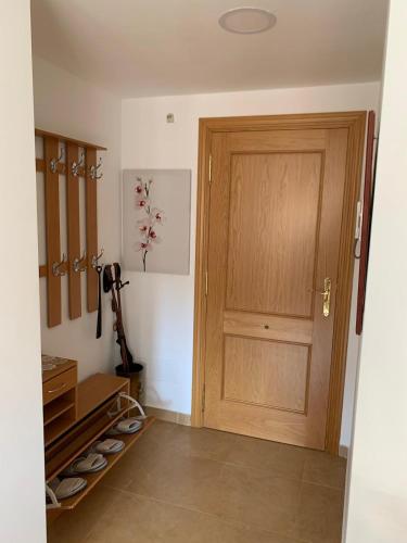 a room with a wooden door and some shoes at El rincon de Adriana in Alquézar