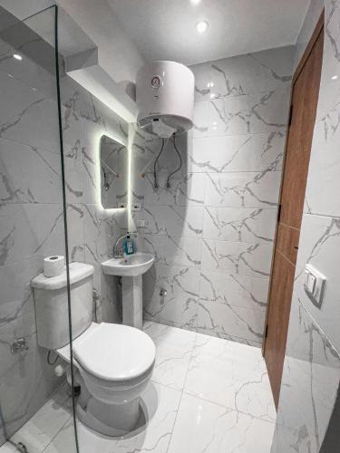 a bathroom with a toilet and a sink at pyramids View Top in Cairo