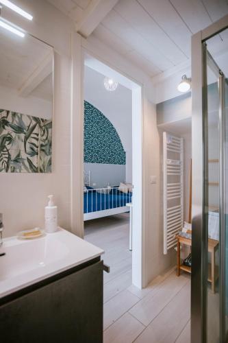 a bathroom with a sink and a room with a crib at Residenza Delle Sirene in Gaeta