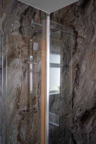 a shower with a glass door in a bathroom at Royal Apartment in Inverness