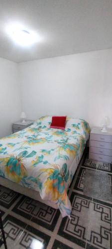 a bedroom with a bed with a colorful comforter at Dulce Adelina III - Zona Céntrica in Río Grande