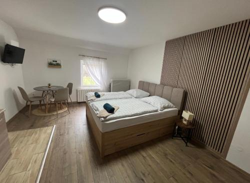 a bedroom with a bed and a table in it at Penzion Chlumec in Český Krumlov