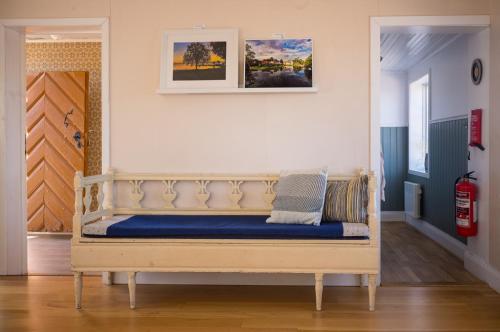 a wooden bench in a room with a wall at Remarkable Harbour View Cabin. in Östhammar