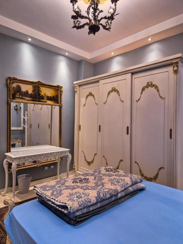 a bedroom with a bed and a dressing table at Galleria 1 in New cairo