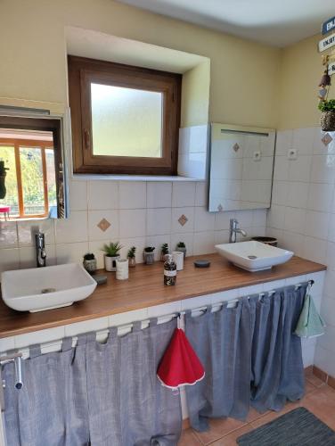 a bathroom with two sinks and a mirror at Gite Agnès & J-Pierre en étage Evasion spa option in Pierre-Châtel
