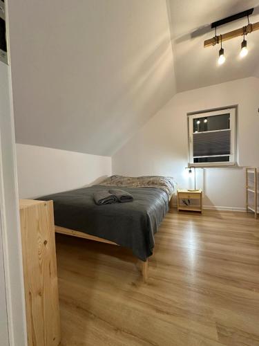 a bedroom with a bed and a window at Domek Nad Rykowiskiem in Jeleśnia