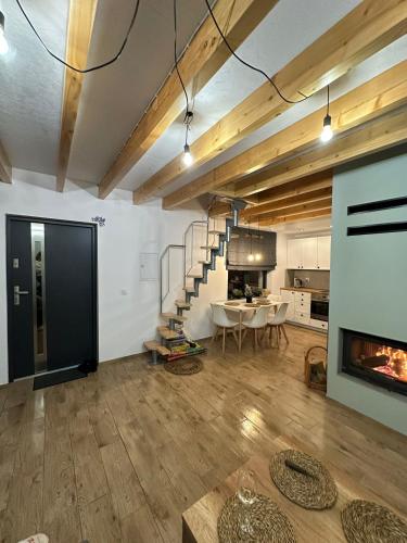 a living room with a fireplace and a table at Domek Nad Rykowiskiem in Jeleśnia