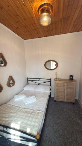a bedroom with a bed and a wooden ceiling at Elia in Kalamoti
