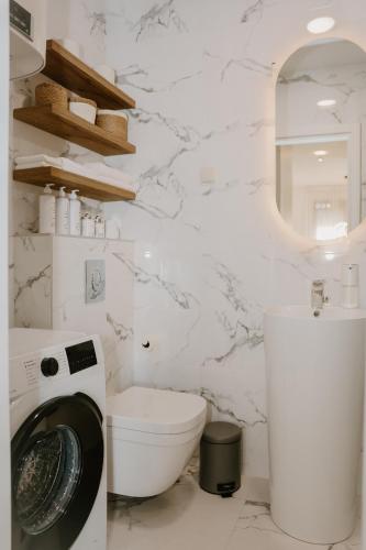 a white bathroom with a toilet and a sink at Bella Vista Residence with private Free Parking in Baošići