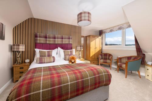 a bedroom with a bed with a teddy bear sitting on it at Royal Apartment in Inverness