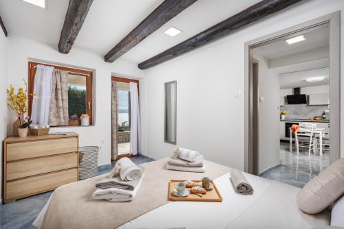 a bedroom with two beds with towels on them at Maestro Apartments Ičići Opatija Riviera in Ičići