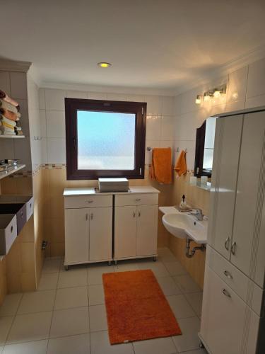 a bathroom with a sink and a window at Side Beach Villarında Dubleks Daire in Side