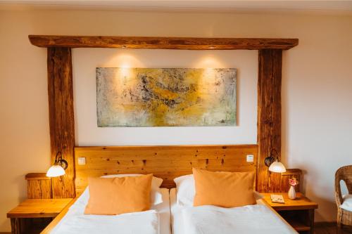 a bedroom with two beds and a painting on the wall at Almenlandhof in Fladnitz an der Teichalm