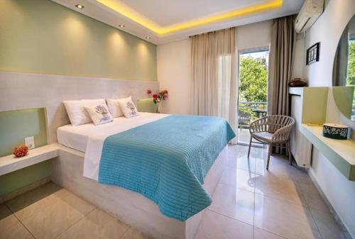 a hotel room with a bed and a chair at Central Thassos luxury Apartment 4u in Limenas