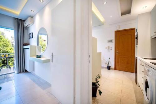 a kitchen with white walls and a door at Central Thassos luxury Apartment 4u in Limenas