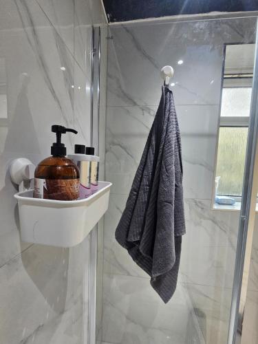 a bathroom with a shower with a sink and a towel at Valgor -3 Bedroom House-Sleeps 5 with free parking-Ideal for contractors, families and group stays-WV6 in Tettenhall