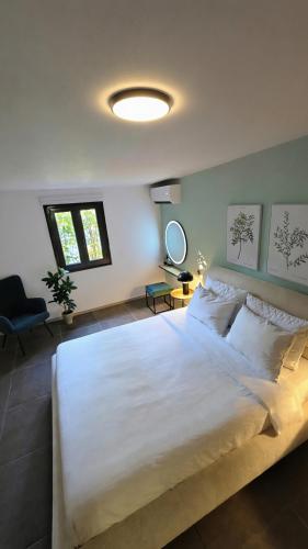 a bedroom with a large bed with a white bedspread at Domus Fidias in Rhodes Town