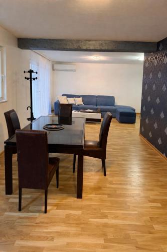 a living room with a table and a blue couch at Pasha House in Belgrade