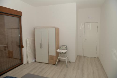 a room with a closet and a chair and a door at Villa Panorama - Private heated pool and jacuzzi with ocean view in Ivanica