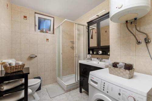 a bathroom with a shower toilet and a sink at Maestro Apartments Ičići Opatija Riviera in Ičići