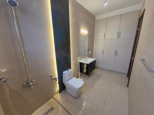a bathroom with a toilet and a sink at Regency Guest House Peshawar in Peshawar