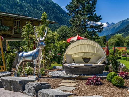 a statue of a deer standing next to a couch at Relais&Châteaux Spa-Hotel Jagdhof in Neustift im Stubaital