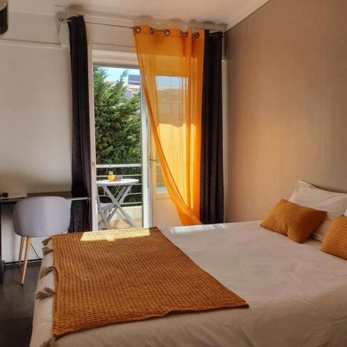 a bedroom with a bed with a view of a balcony at Le Petit Château - Cannes in Cannes