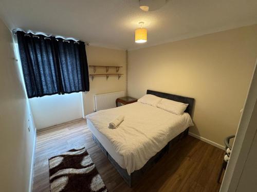 a small bedroom with a bed and a window at Amirs house in Hackington