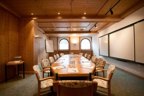 a large conference room with a long table and chairs at Relais&Châteaux Spa-Hotel Jagdhof in Neustift im Stubaital