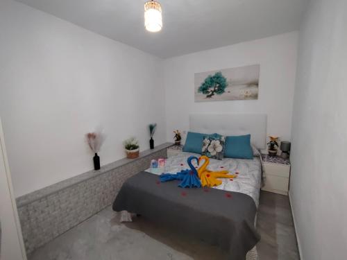 a bedroom with a bed with stuffed animals on it at La magia del sur 2 in Cádiz