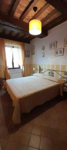 a bedroom with a large bed in a room at Casale La Fornace in Costacciaro