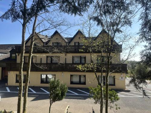 a large building with a balcony on top of it at Hotel Eulenhof in Gransdorf