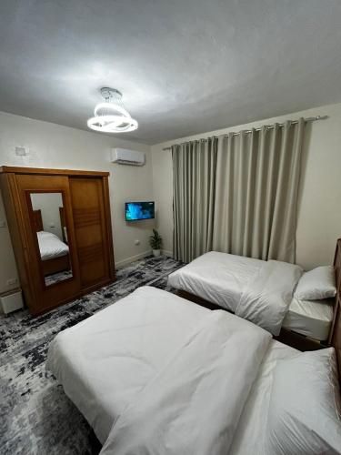 a hotel room with two beds and a mirror at Terra Pyramids Hotel in Cairo