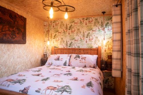 a bedroom with a bed with a floral wallpaper at Parrys Horse box in Exmouth