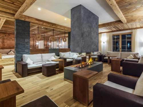a living room with couches and tables at Relais&Châteaux Spa-Hotel Jagdhof in Neustift im Stubaital