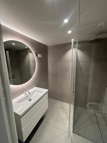 a bathroom with a sink and a shower at Apartment in Central Røa Oslo by the Train Station in Oslo