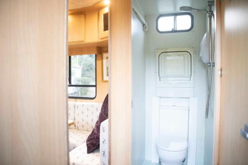 a small bathroom with a toilet in a trailer at Parrys Horse box in Exmouth