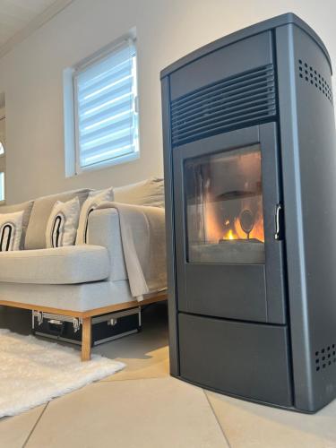 a living room with a fireplace and a tv at Ammersee Garten Appartment in Herrsching am Ammersee