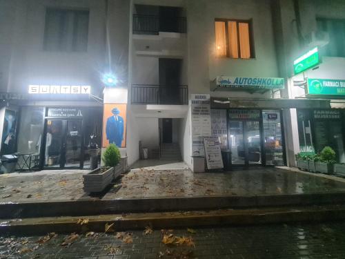 a facade of a building on a street at night at Eyar house in Kamëz