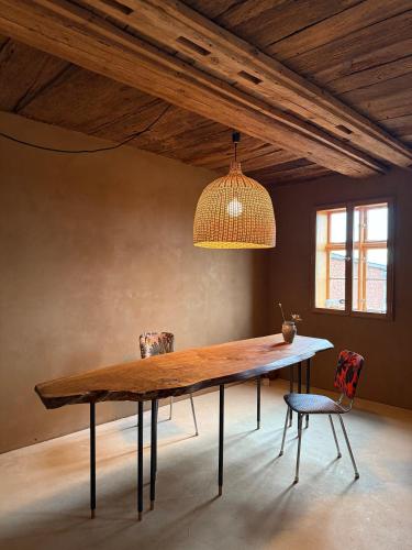 a dining room table with two chairs and a light fixture at Ferienwohnung Fischerhaus Havelberg in Havelberg