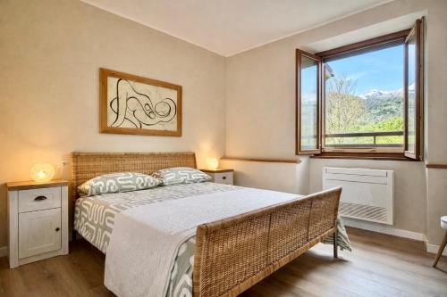 a bedroom with a bed and a window at Casa Cinzia in Gravedona