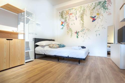 a bedroom with a bed with a painting on the wall at Colibrì in Milan