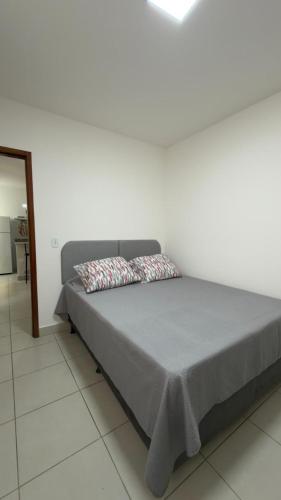 a bed with two pillows on it in a room at Apartamento da Rosa Rua Epaminondas Otoni Número 777 in Teófilo Otoni