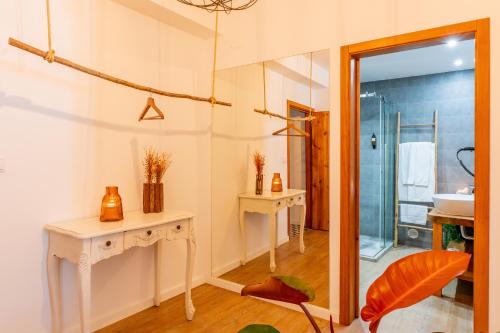 a bathroom with a sink and a mirror at Cangalho Village House Premium in Azueira