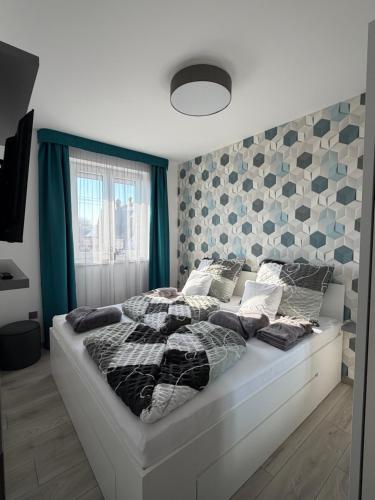a bedroom with a large bed with pillows on it at Minimál Éden in Balatonlelle