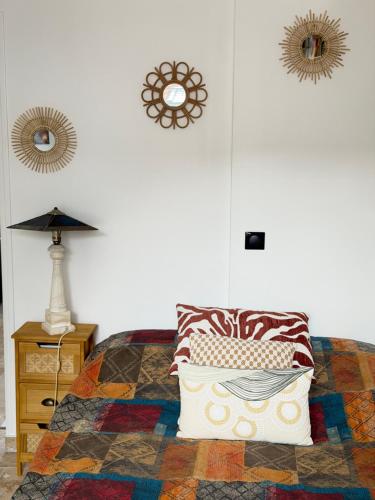 a bedroom with a bed with a pillow and a table at 13th private in Rueil-Malmaison